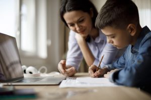 Mother helping teenager with homework